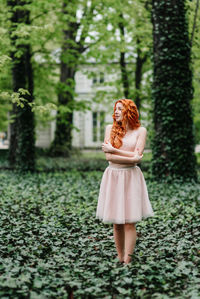 Woman standing by tree