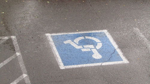 High angle view of disabled sign at parking lot