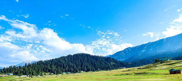 Scenic view of mountains against blue sky