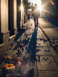 Man walking on illuminated street at night