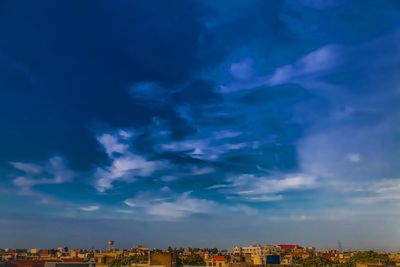 Low angle view of buildings against blue sky