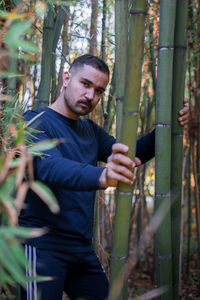 Moroccan man holding a bamboo stem in a public park