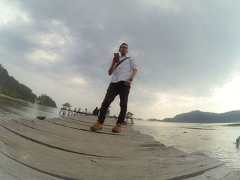 Man standing on beach against sky