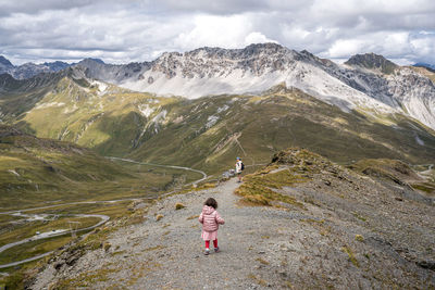 Rear view of man walking on mountain