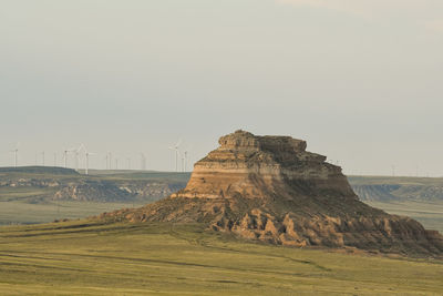 Rock formations on landscape against clear sky