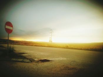 Scenic view of field against sky at sunset