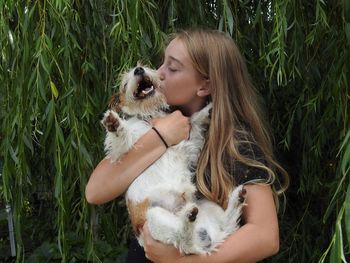 Girl kissing dog