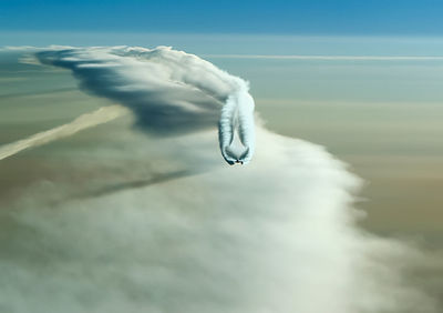 Close-up of vapor trail over sea against sky