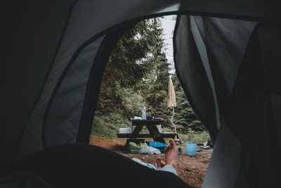 People sitting in tent seen through window
