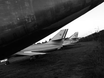 Airplane on land against sky