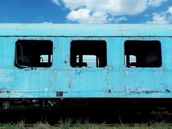 Abandoned train against blue sky