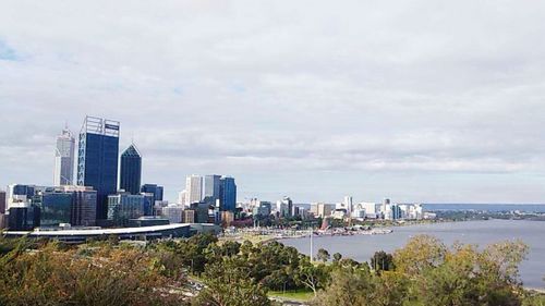 Cityscape against cloudy sky