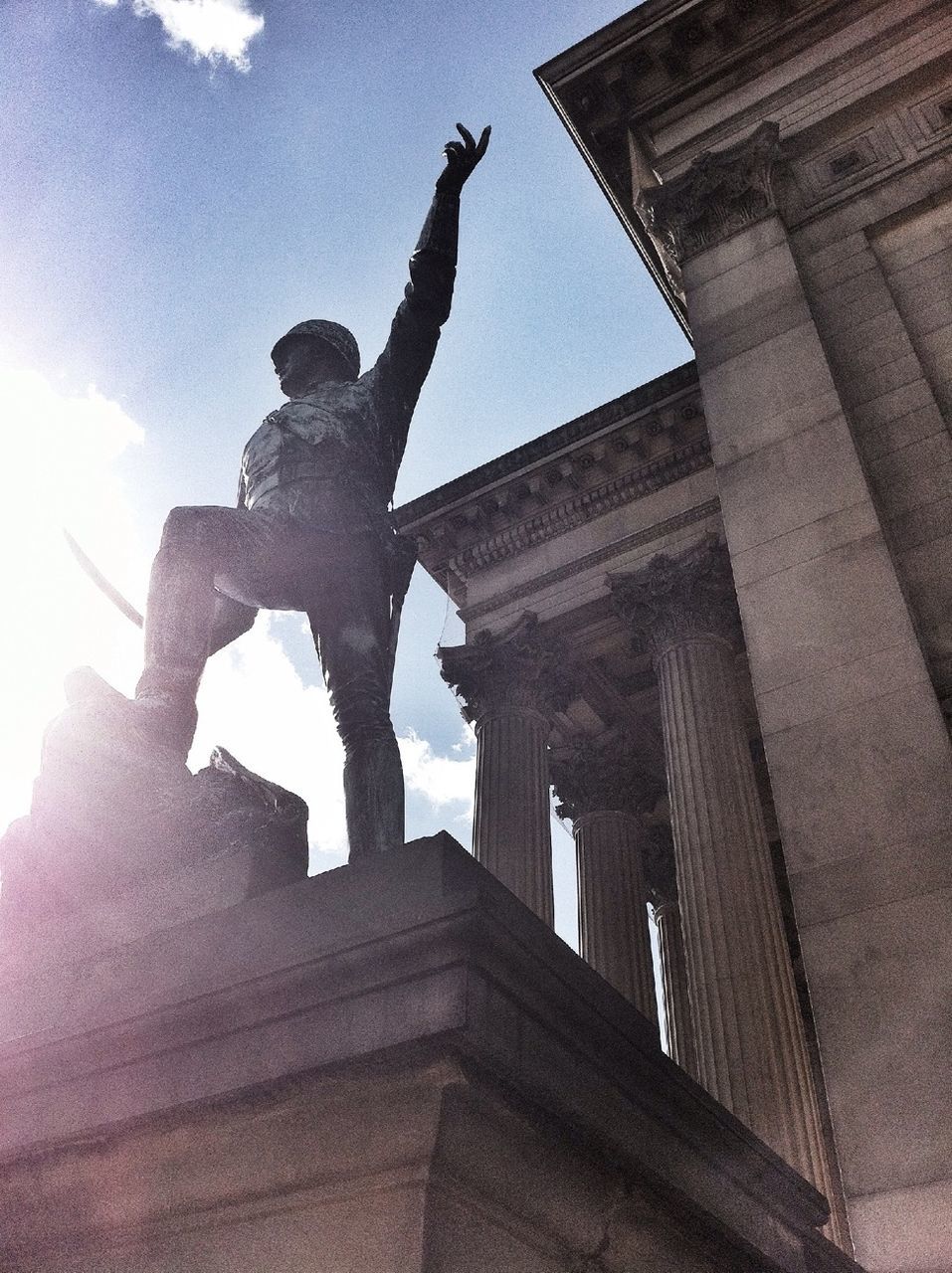 low angle view, sculpture, architecture, statue, built structure, sky, human representation, art and craft, building exterior, famous place, art, history, travel destinations, bird, creativity, animal representation, international landmark, travel, tourism