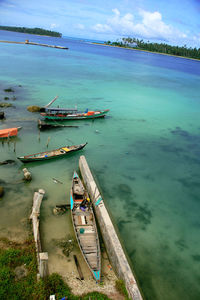 Boats moored on sea against sky