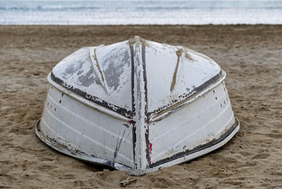 The keel of a small boat capsized on the beach