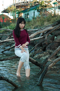 Portrait of a young woman sitting outdoors