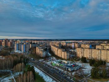 High angle view of river amidst buildings in city against sky