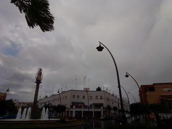 Low angle view of buildings against cloudy sky