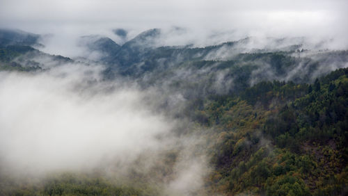 Scenic view of mountains against sky with a low clouds