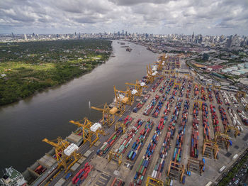 High angle view of commercial dock by river against sky