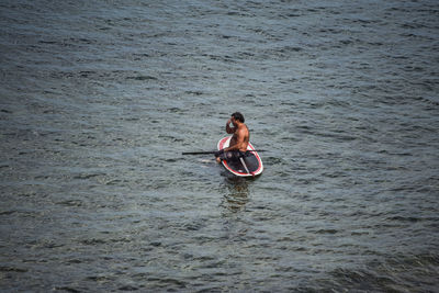 Young woman sitting in sea