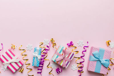 High angle view of christmas decorations against pink background