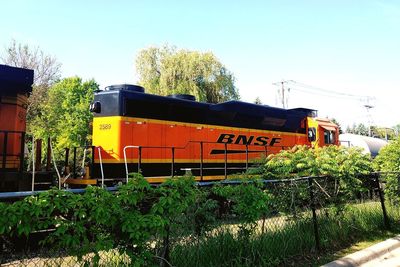 Train on field against clear sky