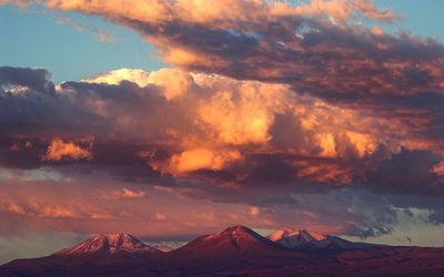 Scenic view of mountains against cloudy sky