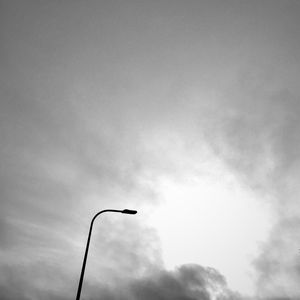 Low angle view of street light against cloudy sky