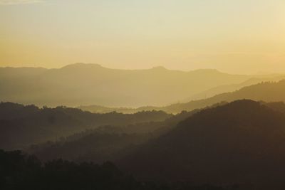 Scenic view of mountains against sky during foggy weather