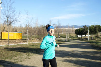 Smiling woman running outdoors