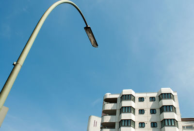 Low angle view of street light and buildings against sky