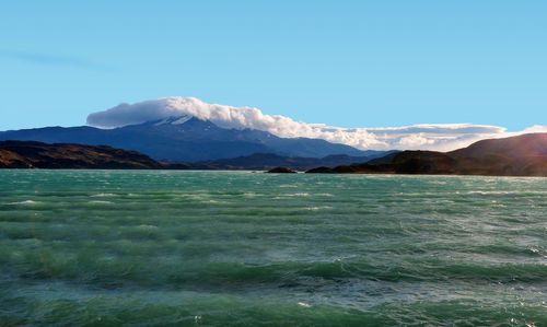 Scenic view of snowcapped mountains against clear blue sky