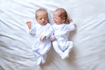 High angle view of baby sleeping on bed