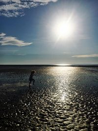 Girl at wet beach on sunny day