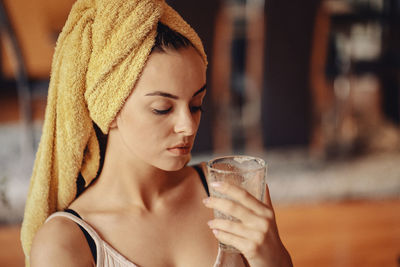 Young beautiful woman with a towel on her head.
