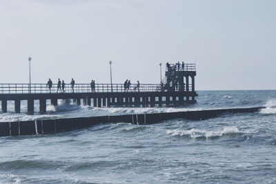 Pier on sea against clear sky