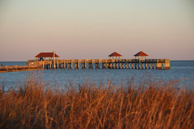 Built structure on beach against clear sky