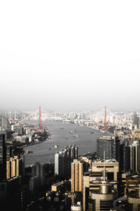 High angle view of buildings in city against clear sky