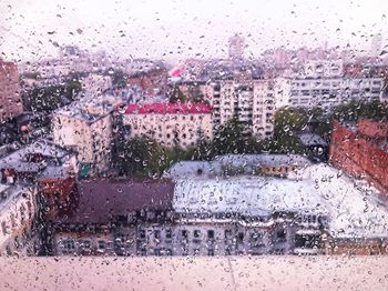 Road seen through wet window in rainy season