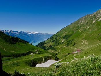 Scenic view of mountains against clear blue sky