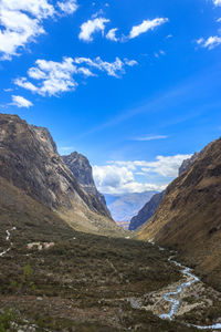 Scenic view of mountains against blue sky