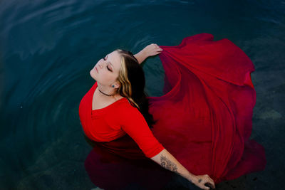 Portrait of young woman standing in lake