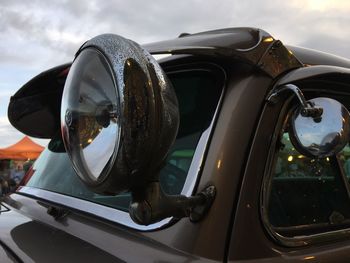 Close-up of vintage car against sky