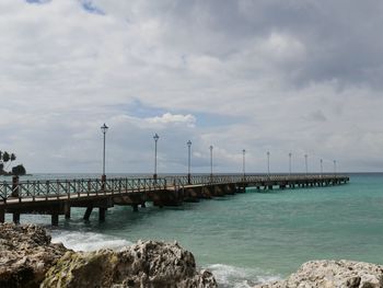 Pier over sea against sky