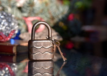 Close-up of old padlock on mirror surface