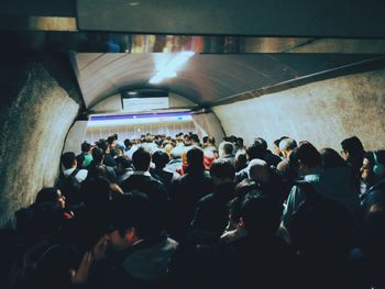 Crowd in illuminated corridor