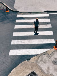 High angle view of man crossing road