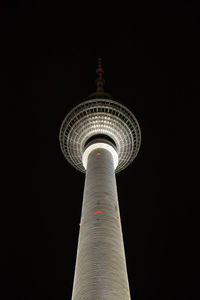 Low angle view of television tower against sky at night