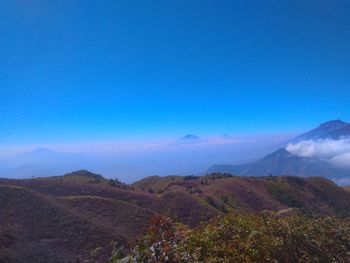 Scenic view of mountains against clear blue sky